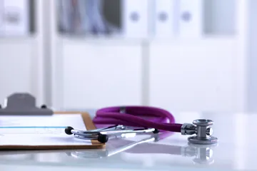 Doctor office with clipboard and stethoscope