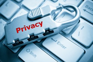 Lock with the word privacy on it, sitting on a keyboard