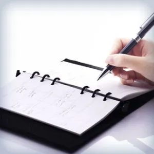 Person filling in appointment book