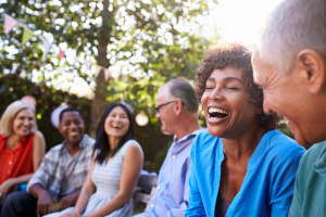 group of friends sitting outside and laughing together
